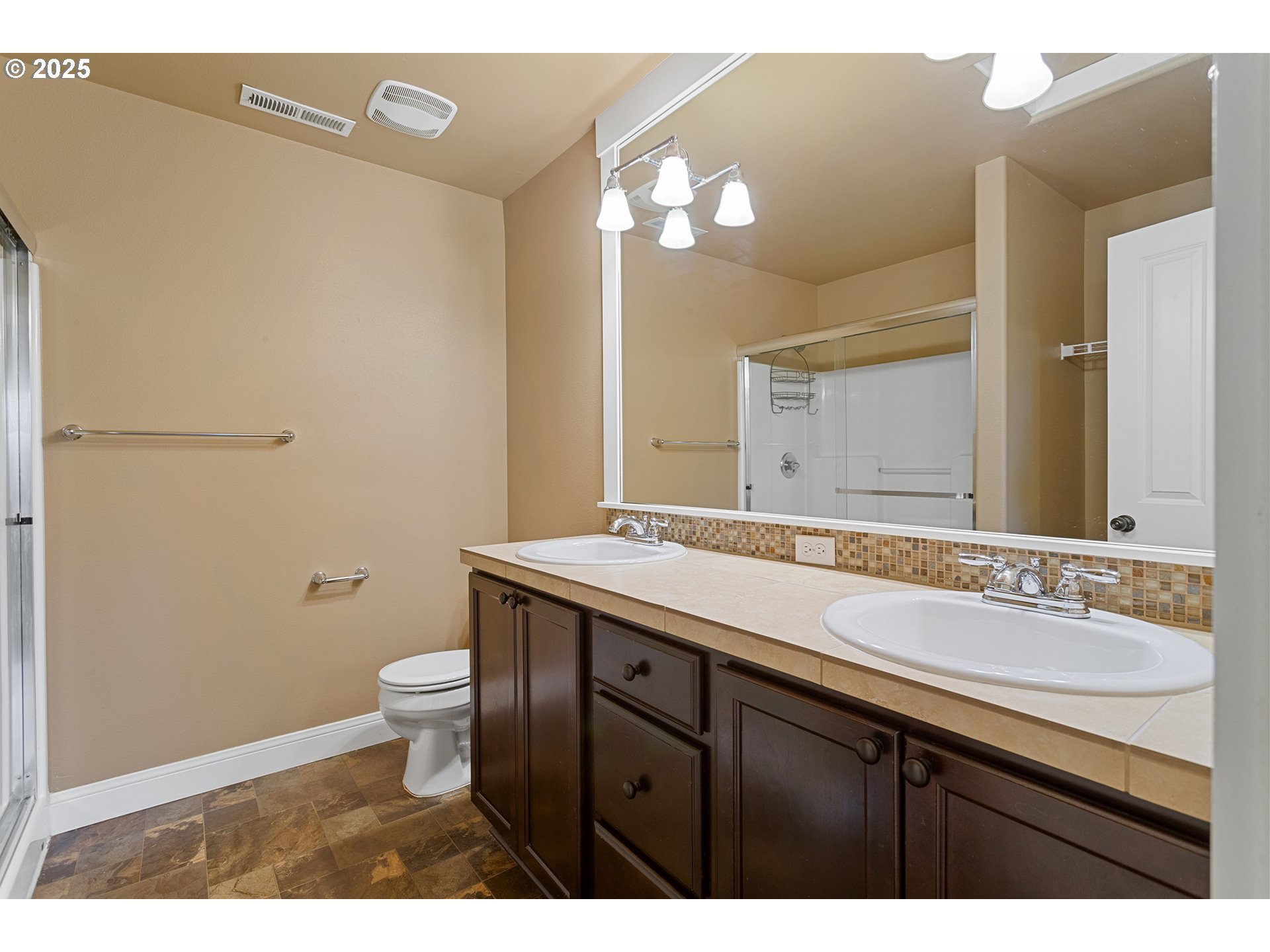 9622 Southwest Everett Terrace Tigard, OR 97223 - Photo 30 of 43 a bathroom with a granite countertop sink a toilet and a mirror