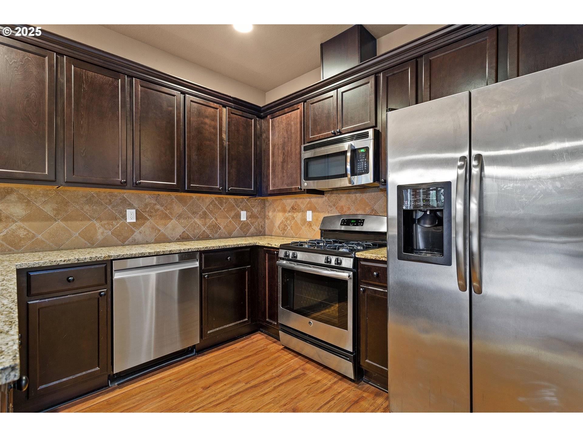 9622 Southwest Everett Terrace Tigard, OR 97223 - Photo 6 of 43 a kitchen with granite countertop stainless steel appliances and wooden cabinets