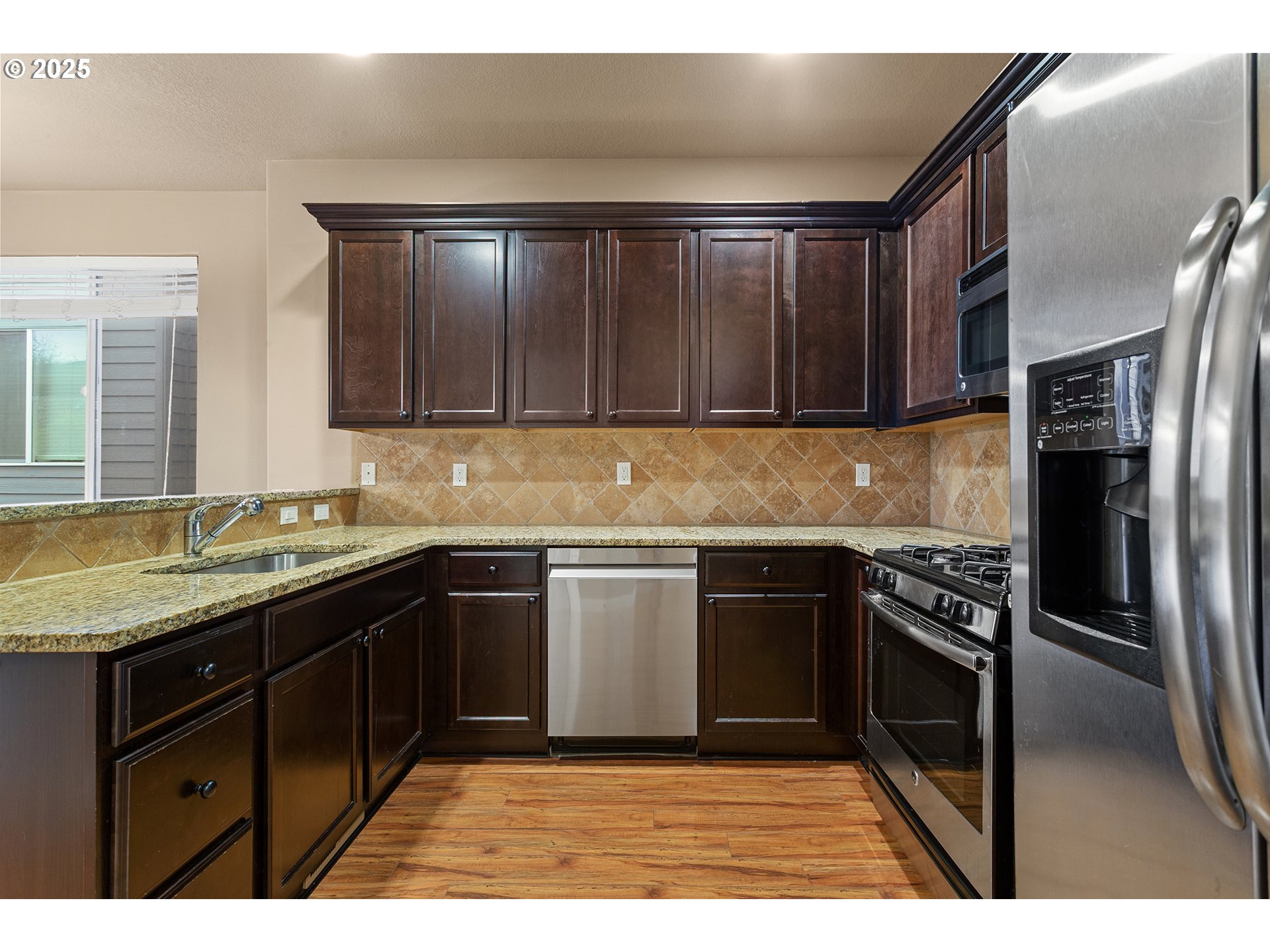 9622 Southwest Everett Terrace Tigard, OR 97223 - Photo 8 of 43 a kitchen with a sink stove and refrigerator