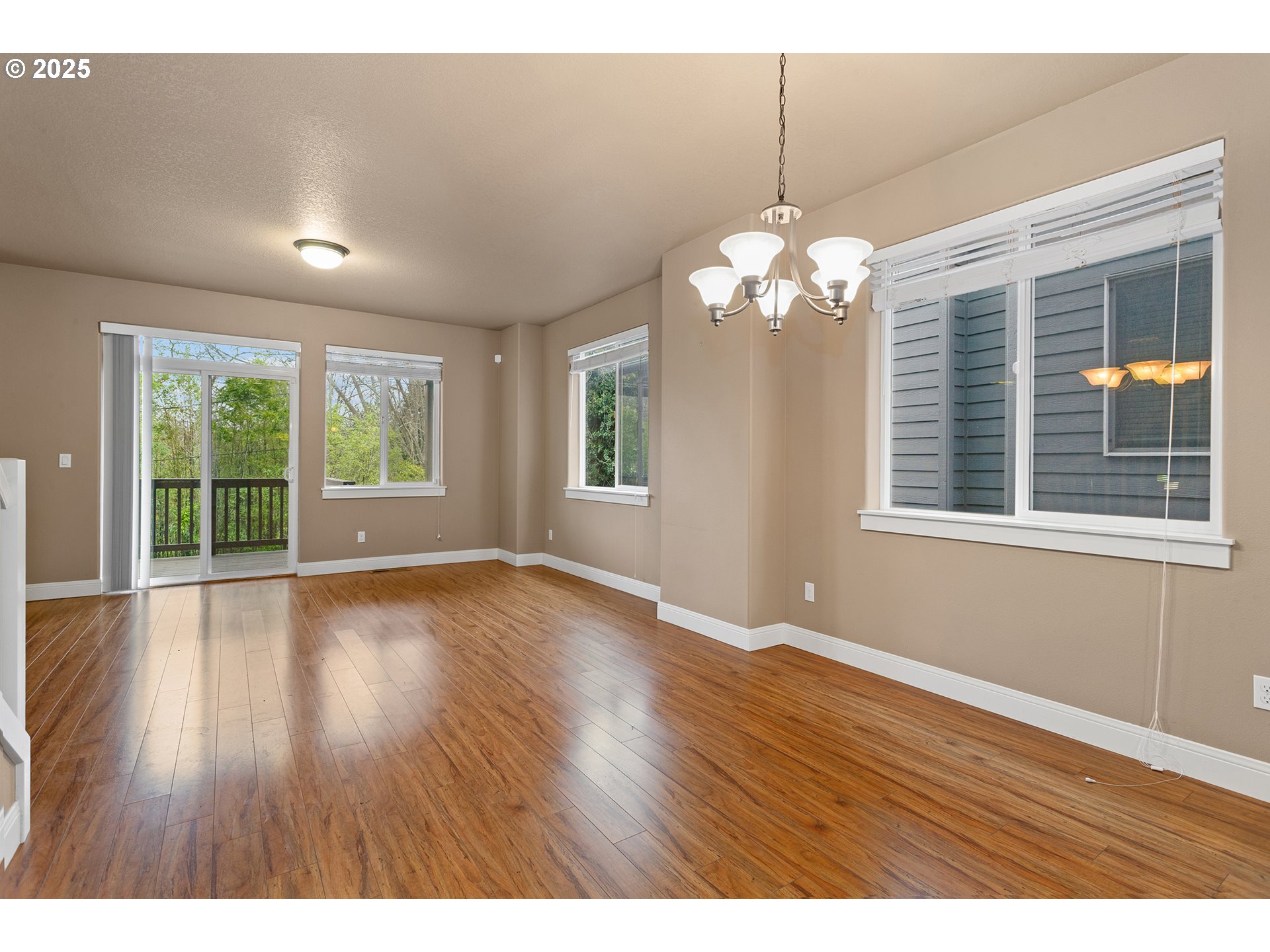 9622 Southwest Everett Terrace Tigard, OR 97223 - Photo 10 of 43 a view of an empty room with wooden floor and a window