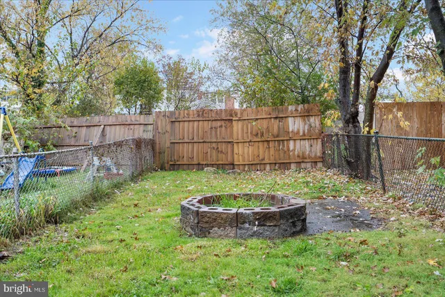 a view of a backyard with a tub and plants