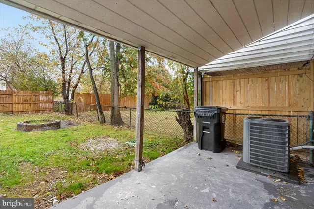 a view of a porch with couches and wooden fence