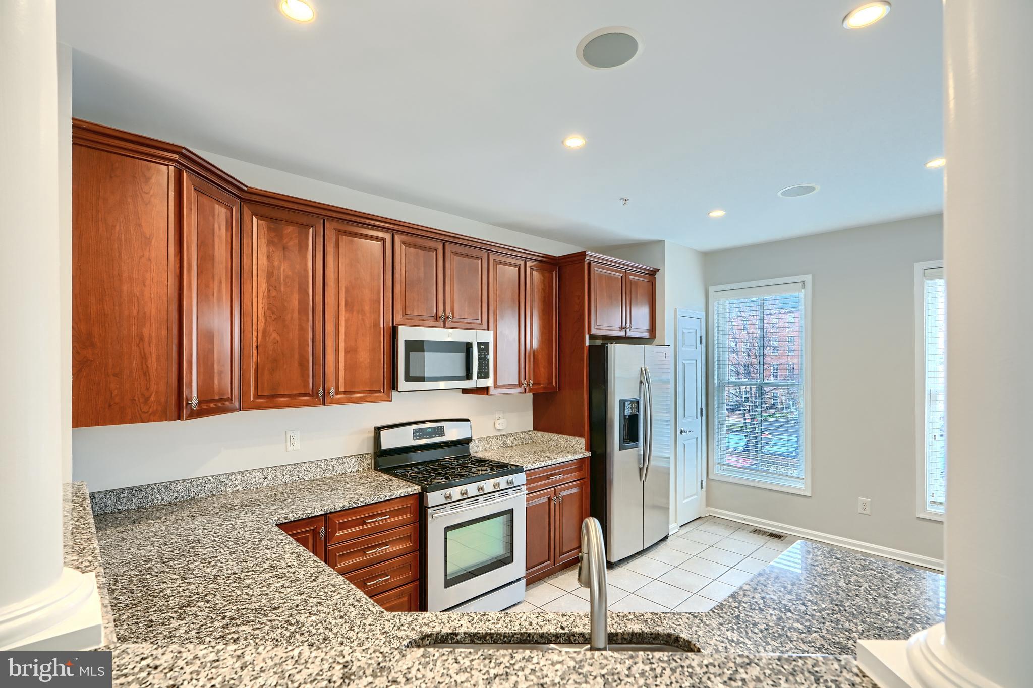 1205 Dockside Circle Baltimore, MD 21224 - Photo 17 of 39 a kitchen with stainless steel appliances granite countertop a refrigerator stove and sink
