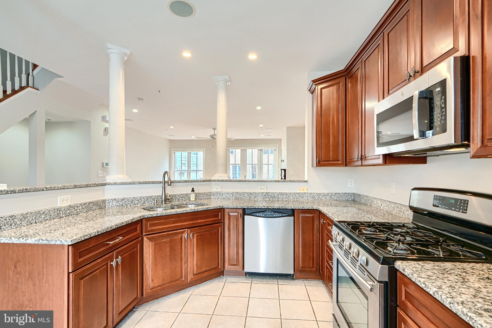 1205 Dockside Circle Baltimore, MD 21224 - Photo 19 of 39 a kitchen with stainless steel appliances granite countertop a stove and a sink