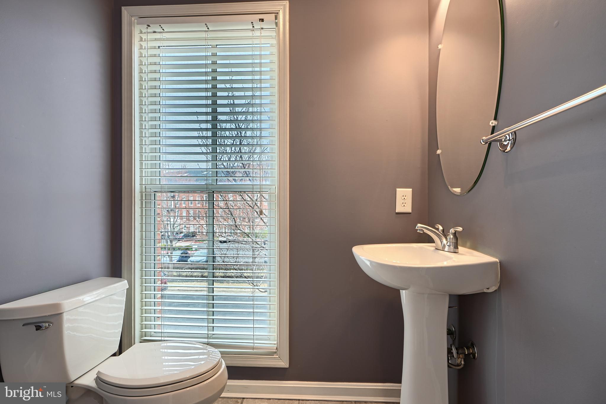 1205 Dockside Circle Baltimore, MD 21224 - Photo 21 of 39 a bathroom with a sink a toilet and a mirror
