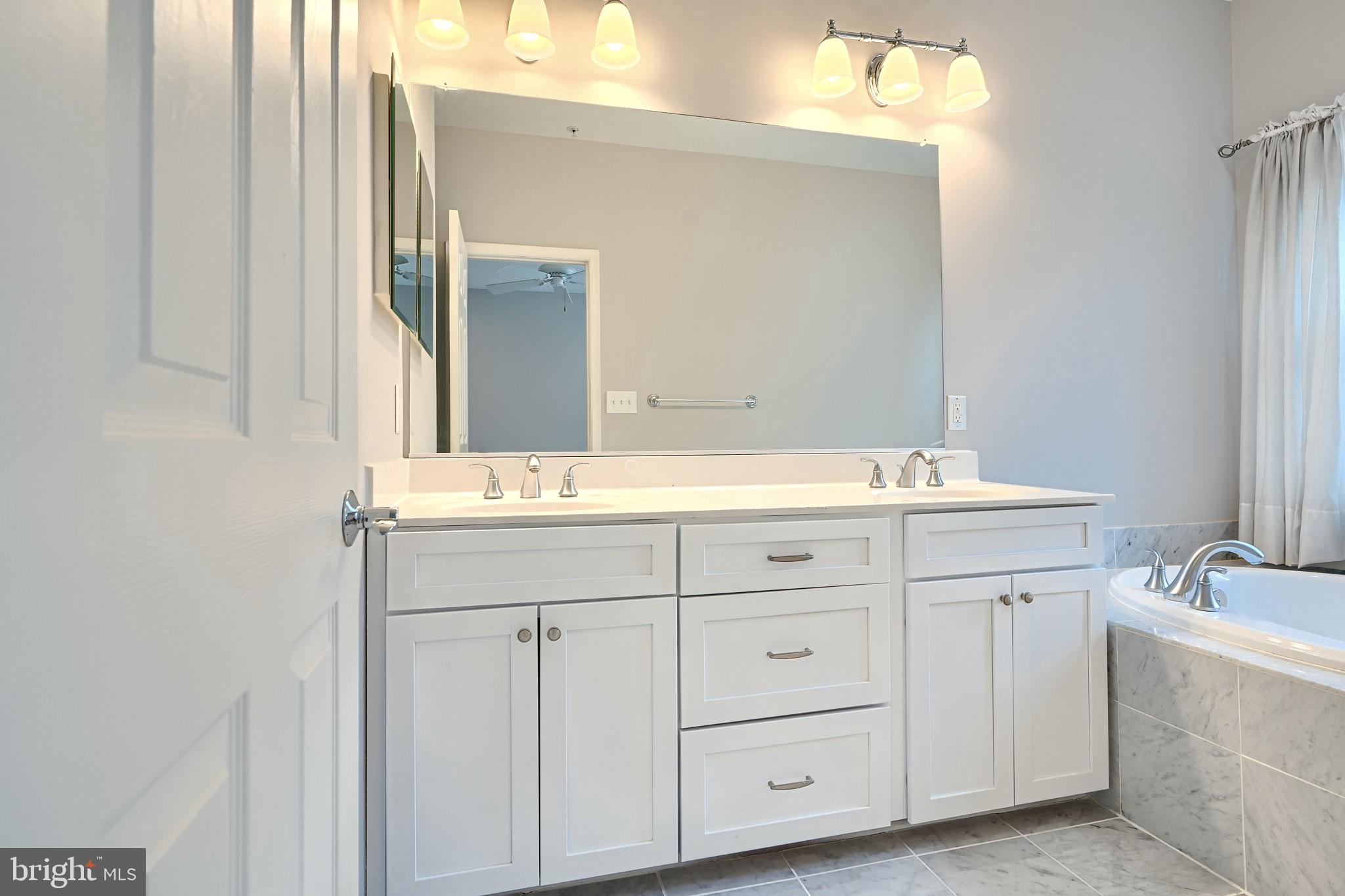 1205 Dockside Circle Baltimore, MD 21224 - Photo 26 of 39 a bathroom with a sink and a mirror