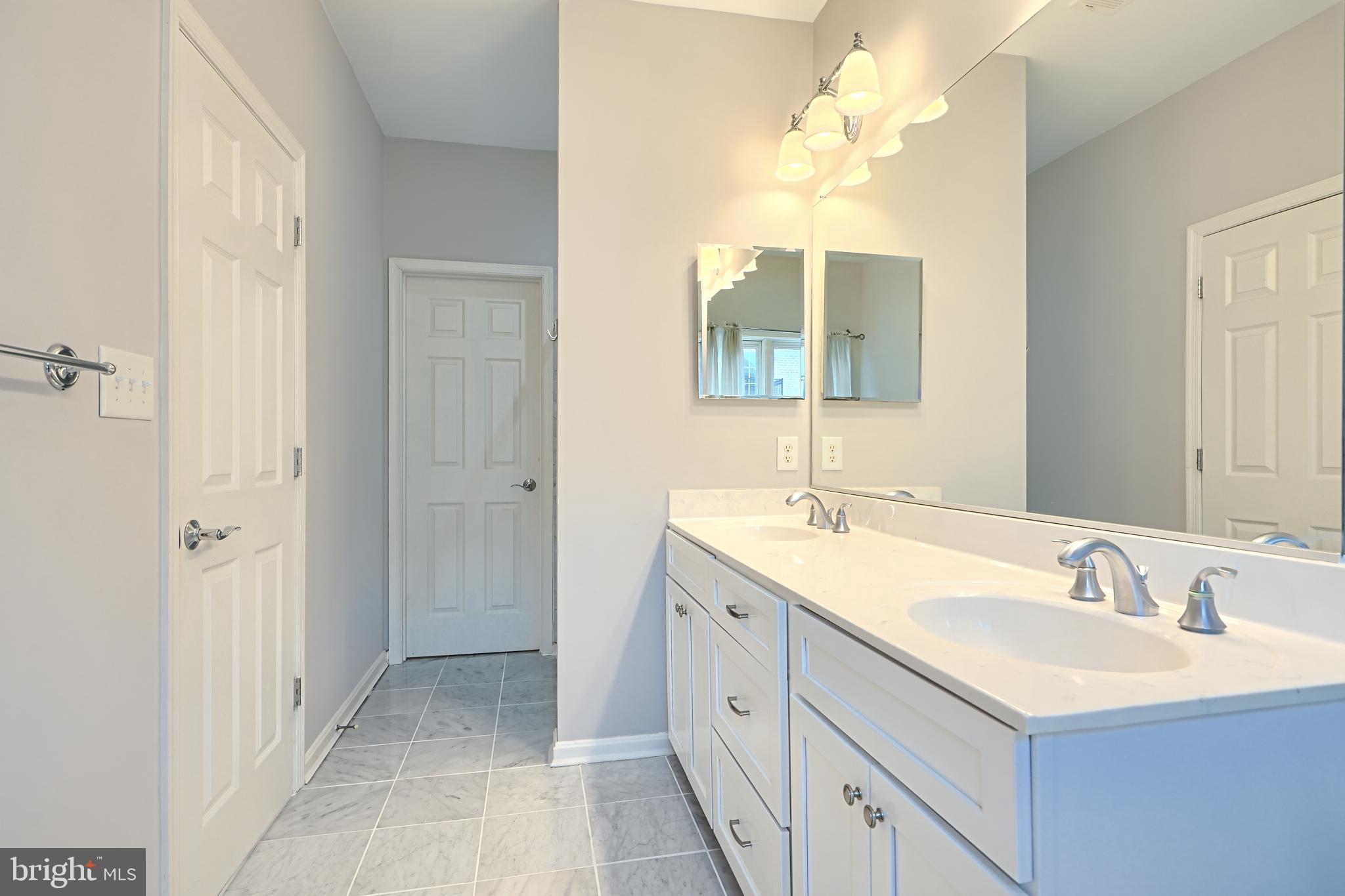 1205 Dockside Circle Baltimore, MD 21224 - Photo 29 of 39 a bathroom with a sink and a mirror