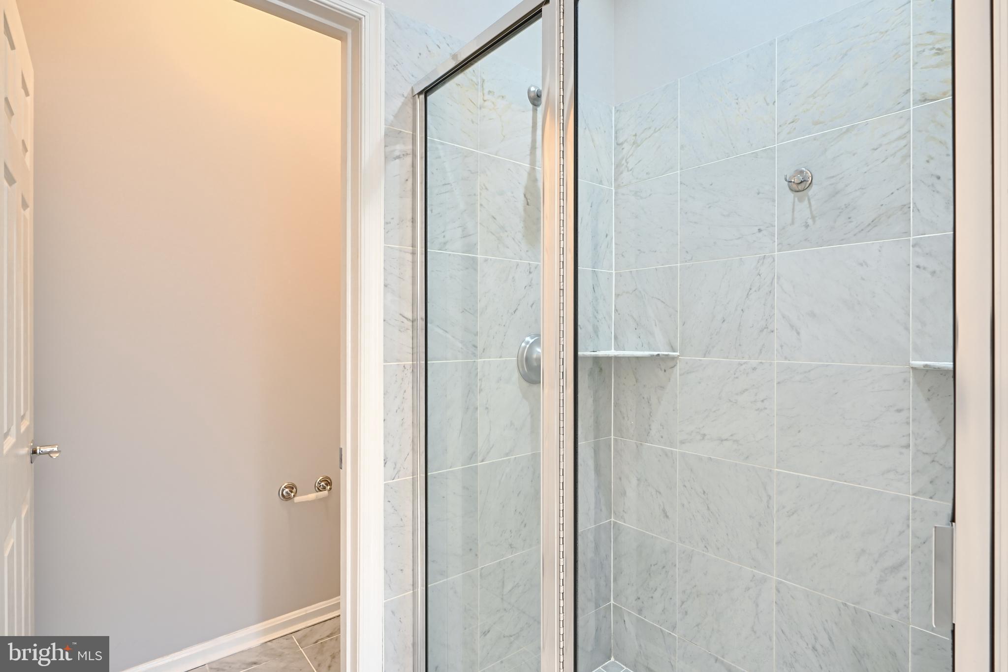 1205 Dockside Circle Baltimore, MD 21224 - Photo 30 of 39 a bathroom with a glass shower door