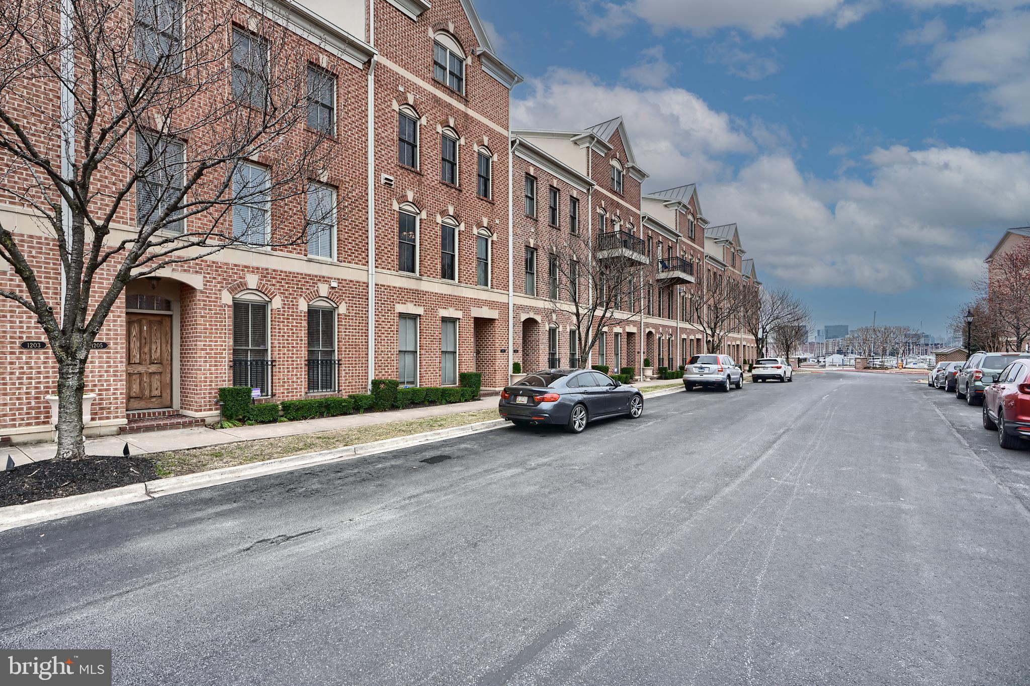 1205 Dockside Circle Baltimore, MD 21224 - Photo 3 of 39 a city street lined with buildings and cars