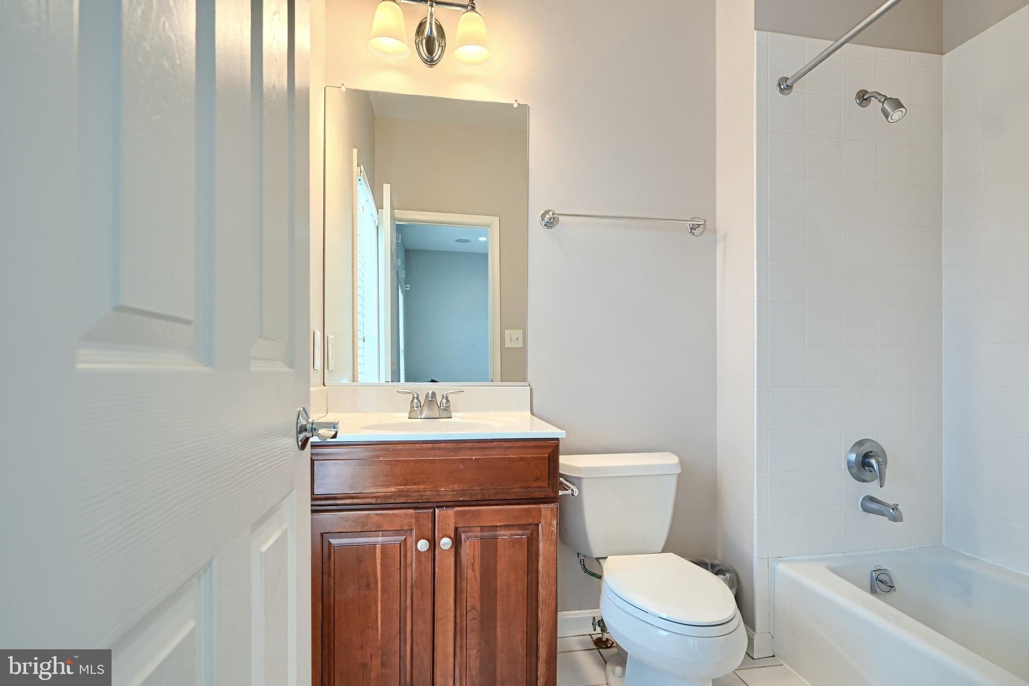 1205 Dockside Circle Baltimore, MD 21224 - Photo 35 of 39 a bathroom with a sink a toilet and shower