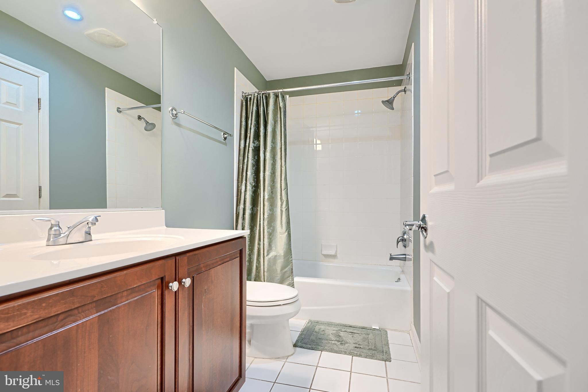 1205 Dockside Circle Baltimore, MD 21224 - Photo 9 of 39 a bathroom with a granite countertop sink toilet and shower