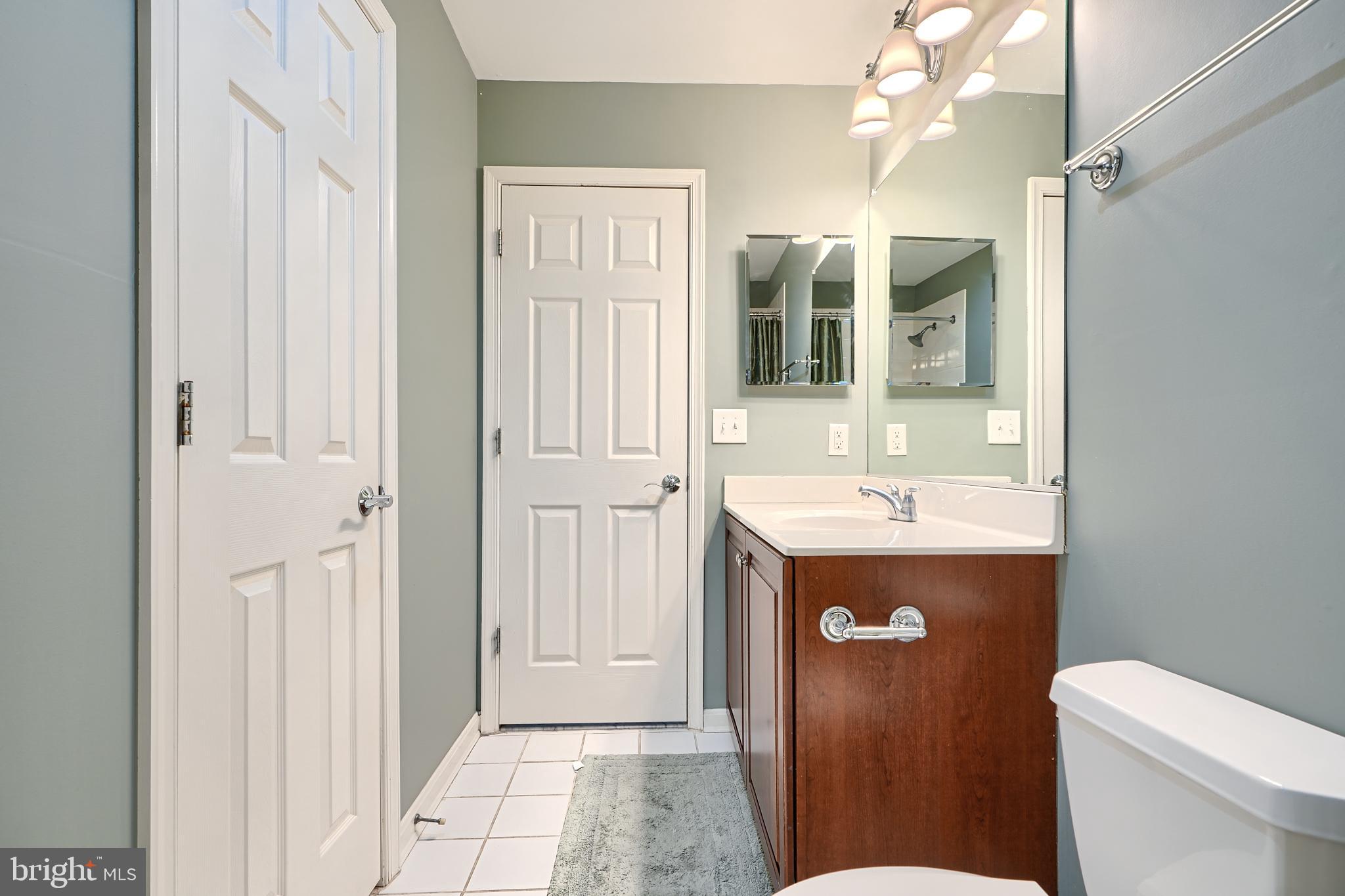 1205 Dockside Circle Baltimore, MD 21224 - Photo 10 of 39 a bathroom with a sink a toilet and shower