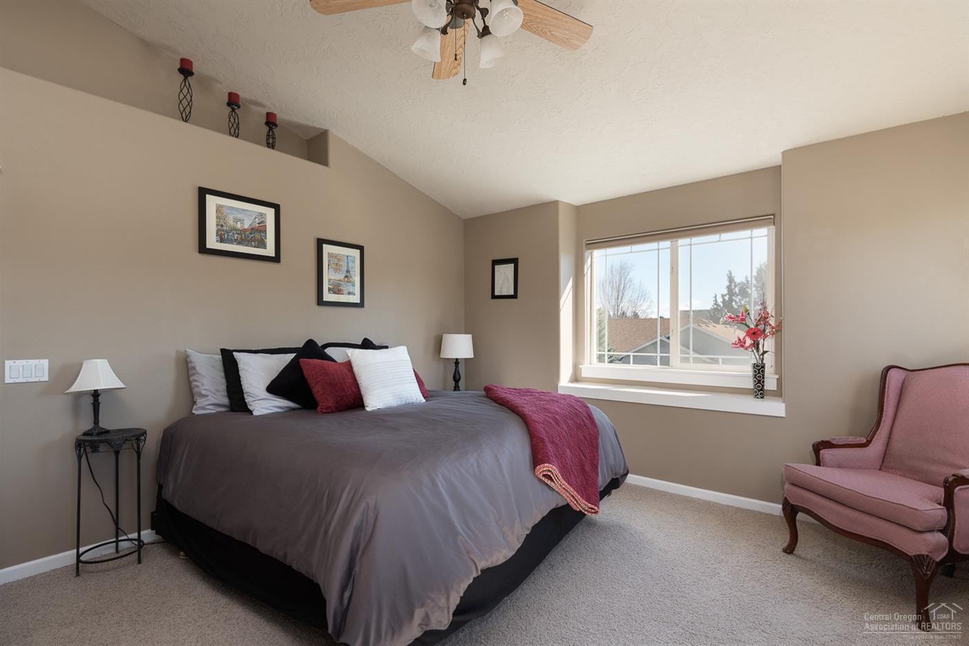 3341 Northeast Stonebrook Loop Bend, OR 97701 - Photo 13 of 25 a bed room with a bed and a chair