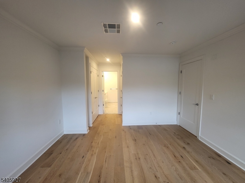 18 Ward Street Bloomfield, NJ 07003 - Photo 11 of 20 an empty room with wooden floor and windows