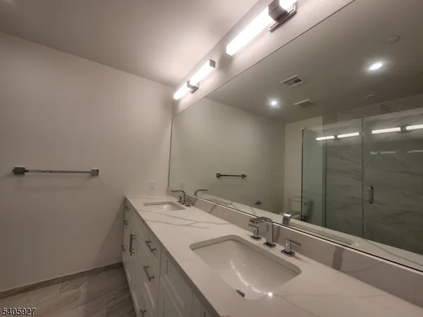 a bathroom with a double vanity sink and a mirror