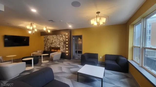 a living room with furniture a lamp and a flat screen tv