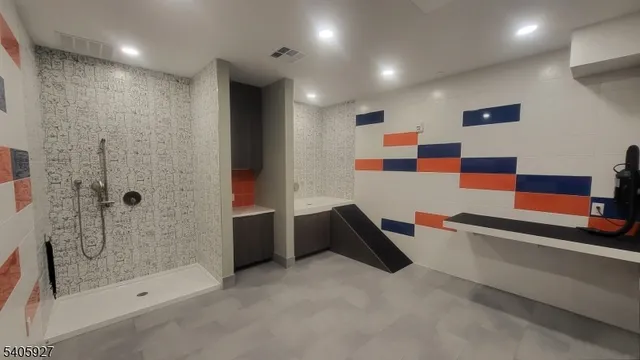 a bathroom with a bathtub and a shower