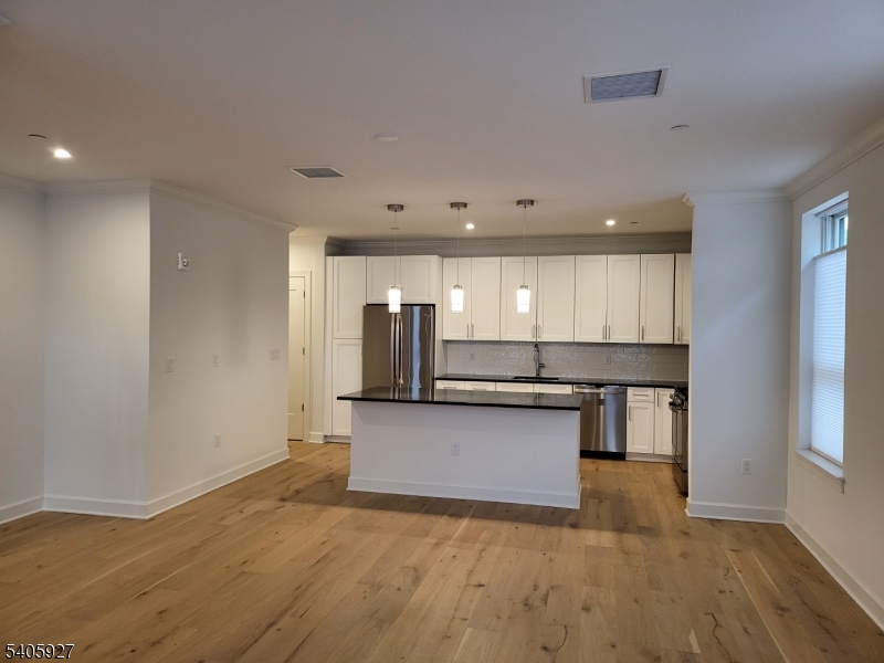 18 Ward Street Bloomfield, NJ 07003 - Photo 3 of 20 a view of kitchen with stainless steel appliances wooden floor and window