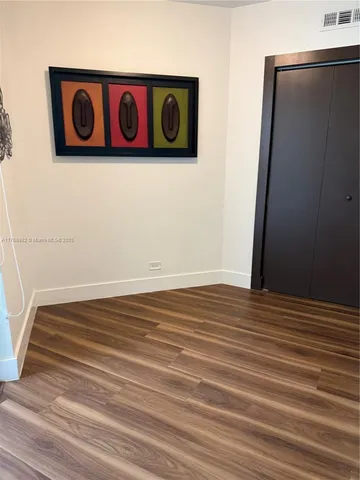 a view of a door with wooden floor