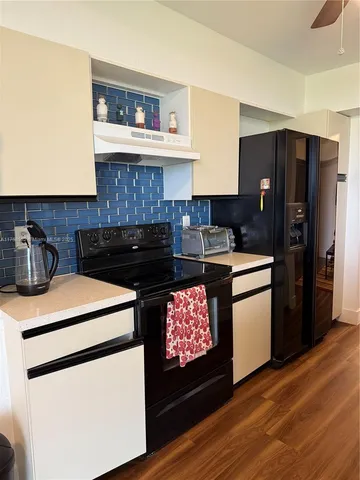 a kitchen with stainless steel appliances granite countertop a stove a refrigerator and a microwave