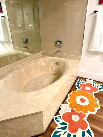 a bathroom with a tub and a sink