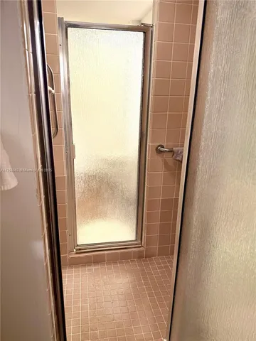 a bedroom with bed and a large window