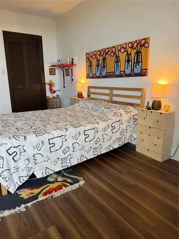 a bedroom with an oven and a bed