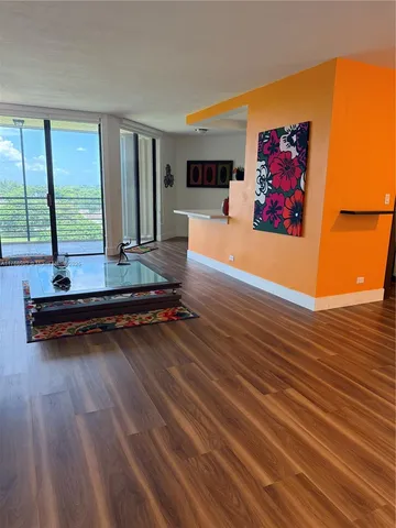 a room with wooden floor and furniture