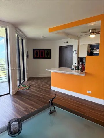 a room with pool table and windows