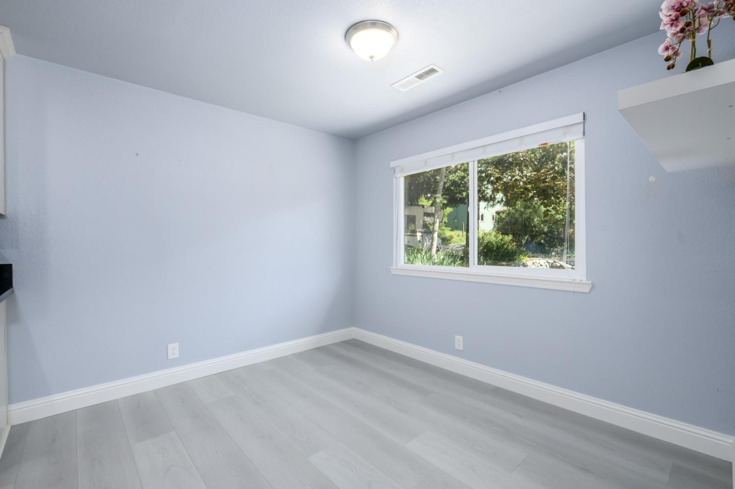2873 Anderson Way Placerville, CA 95667 - Photo 13 of 24 an empty room with wooden floor and windows