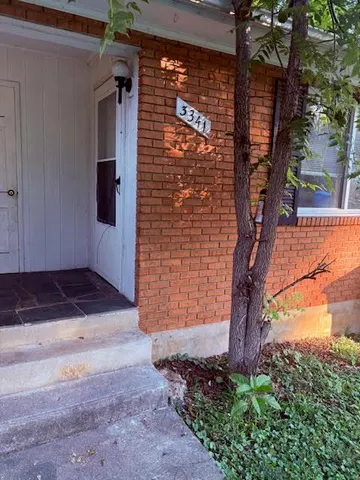 a brick building with a tree in front of it