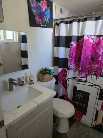 a bathroom with a toilet and a shower