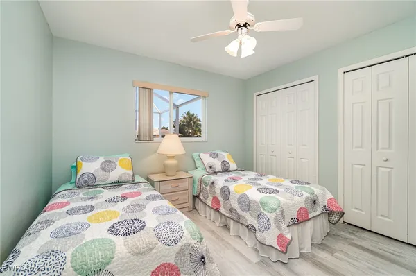 a bedroom with two beds and a chandelier