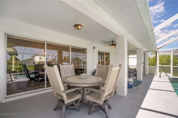 a dining room with furniture and large windows