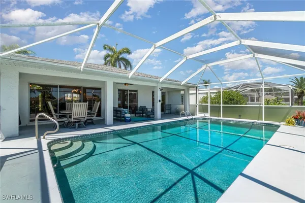 a view of a house with a backyard porch and sitting area