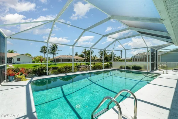 a view of a swimming pool with a patio and a garden