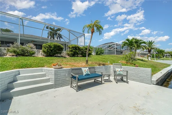 a view of a patio with a table and chairs