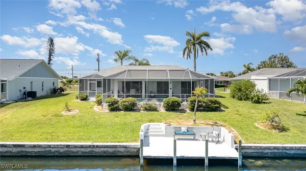 a view of a house with swimming pool and a yard