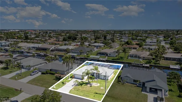 an aerial view of residential houses with yard