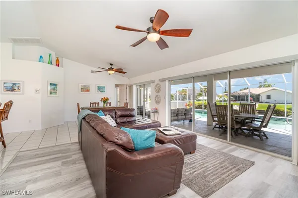 a living room with furniture ceiling fan and a rug