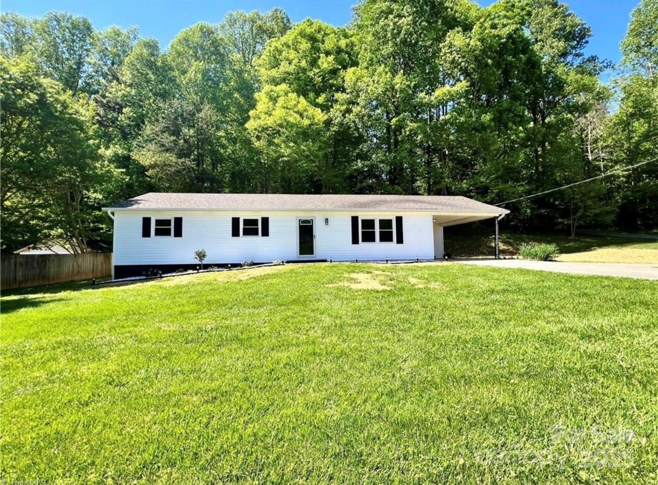 a aerial view of a house with swimming pool next to a yard
