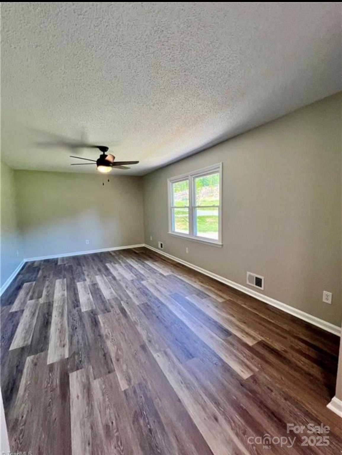 276 Country Club Road Wilkesboro, NC 28697 - Photo 13 of 16 a view of empty room with wooden floor and fan
