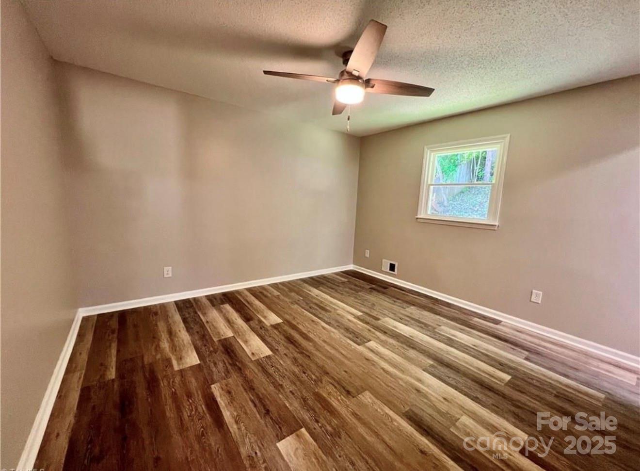 276 Country Club Road Wilkesboro, NC 28697 - Photo 10 of 16 a view of a room with wooden floor and fan