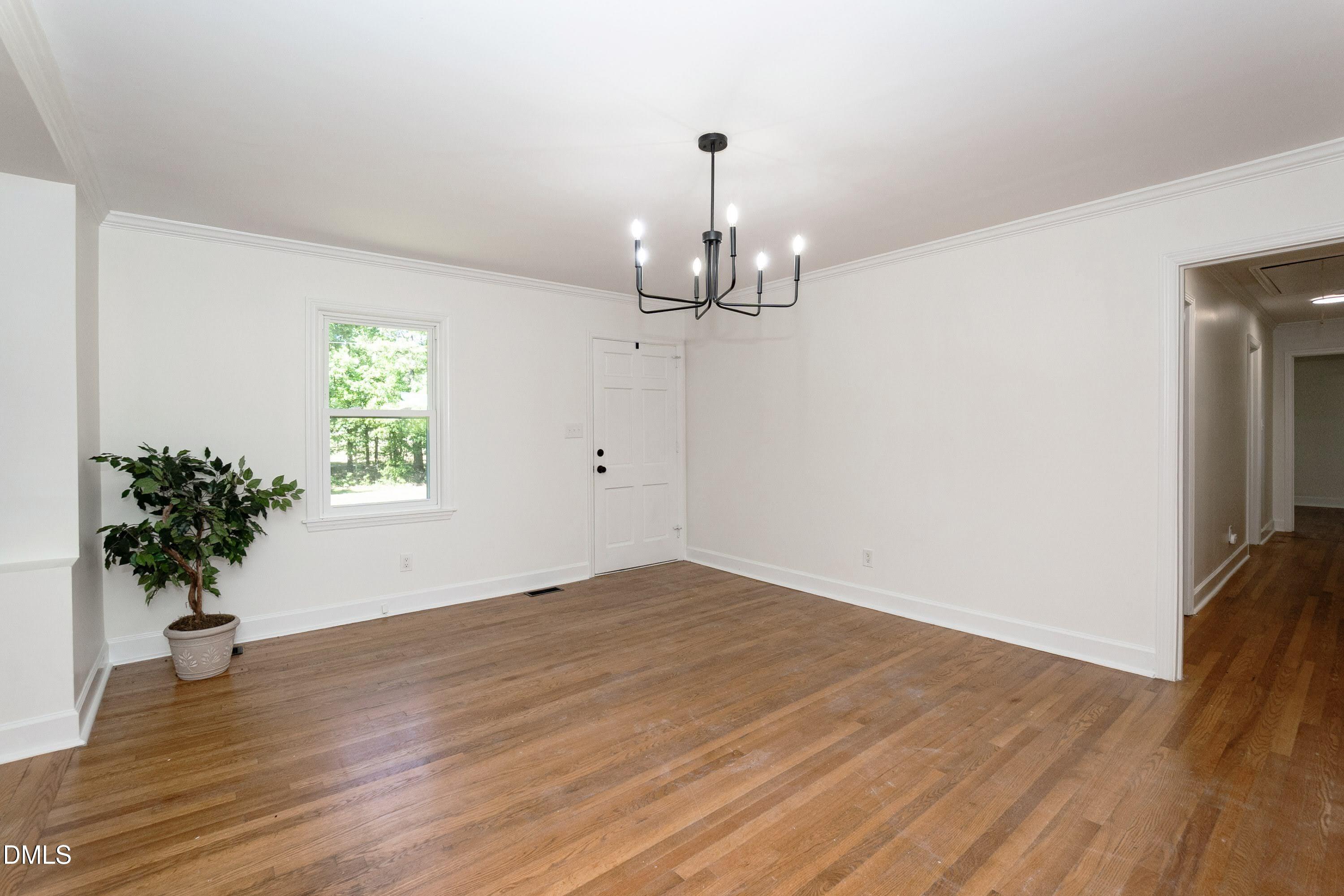 641 Rocky Ford Road Louisburg, NC 27549 - Photo 14 of 38 a view of an empty room with wooden floor and a window