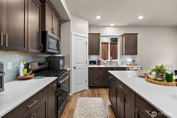 a kitchen with a sink stainless steel appliances and cabinets