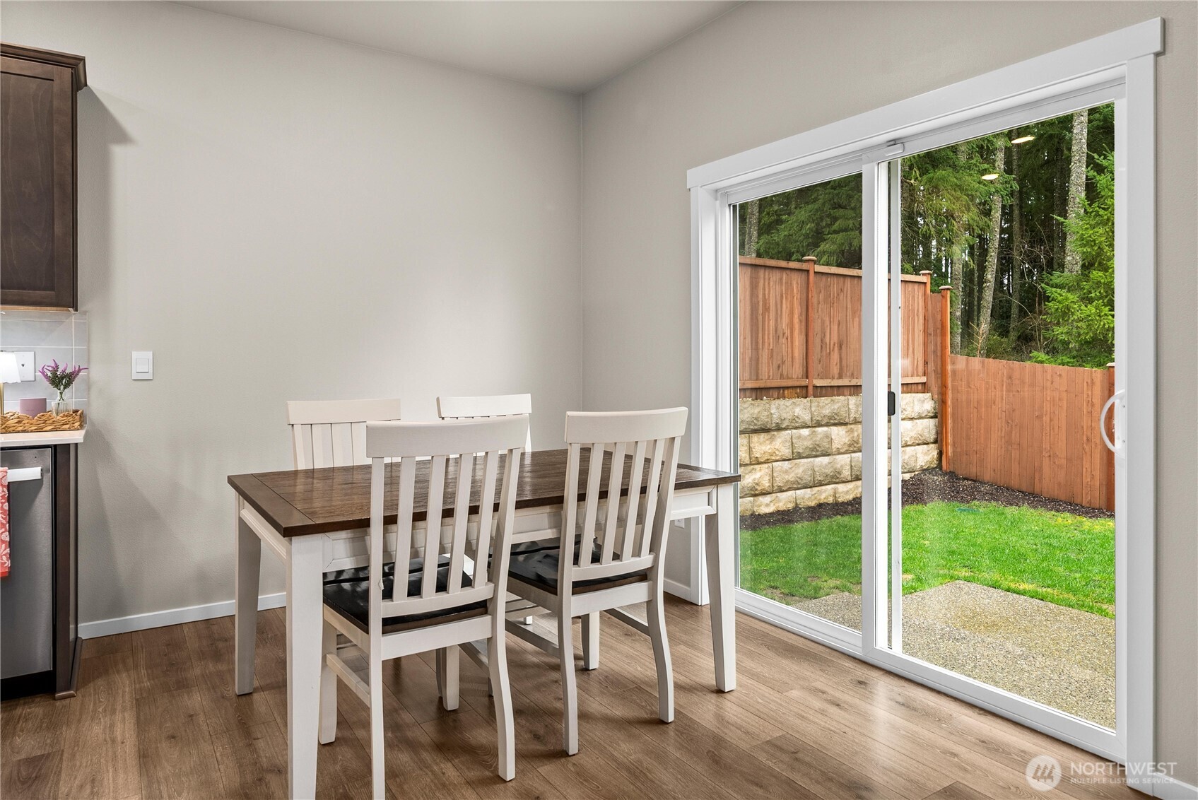 1081 Southwest Pendleton Way Port Orchard, WA 98367 - Photo 9 of 40 a view of a dining room with furniture wooden floor and floor to ceiling window