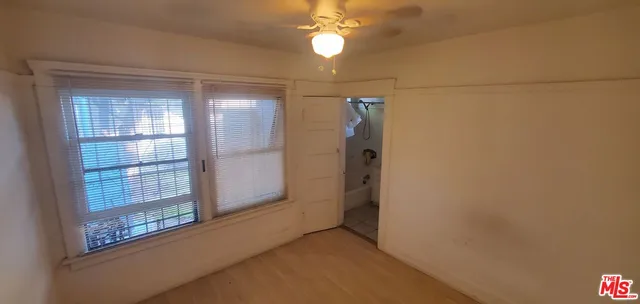 a view of empty room with ceiling fan