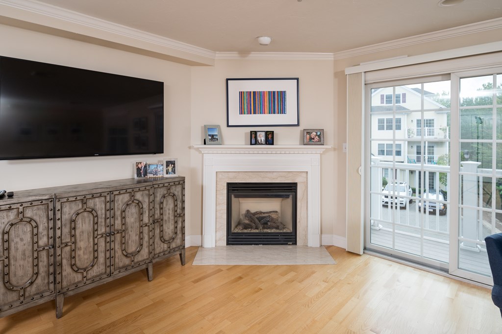29 Maple Street, Unit E Canton, MA 02021 - Photo 13 of 23 a living room with furniture a flat screen tv and a fireplace