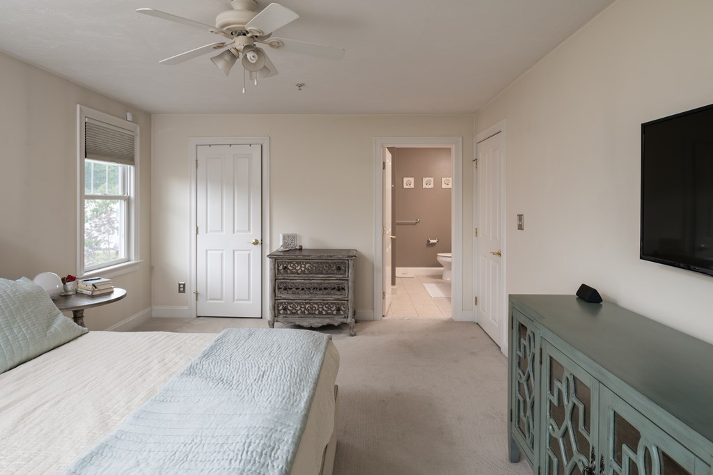 29 Maple Street, Unit E Canton, MA 02021 - Photo 19 of 23 a spacious bedroom with a bed and a flat screen tv