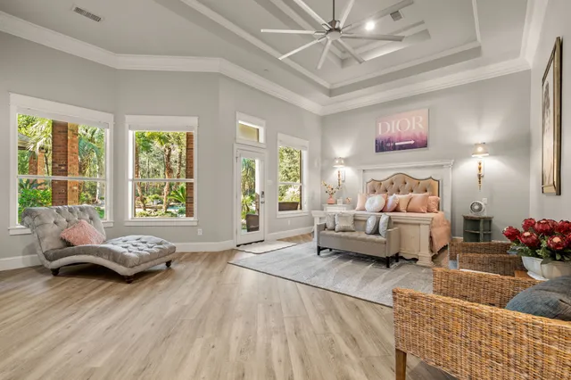 a spacious bedroom with a large bed and a chandelier